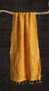 Mustard yellow scarf on a wooden hanger against a black background