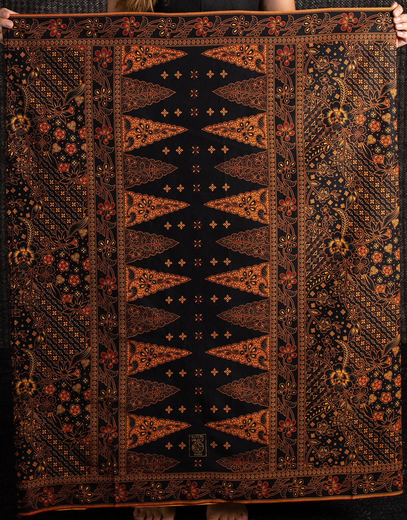 Woman holding a large patterned cotton batik sarong 
